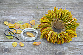 Wreath of beech leaves, wire and scissors