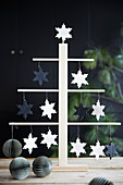 Stylised Christmas tree decorated with snowflakes and paper honeycomb baubles