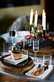 Festive place setting on table set for Christmas with four candles