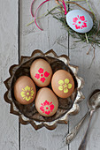 Grey Easter eggs with neon flower motifs