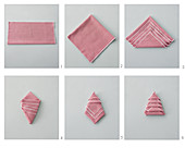 Instructions for folding napkins into Christmas-tree shapea