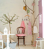 Birch branch used as coat stand in summery foyer
