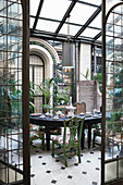 Festively set table in restored Florentine conservatory