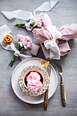Gift wrapped in fabric and posies of pink carnations