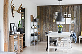 Country-house-style dining room with rustic board wall