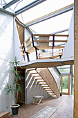 Wooden staircase in open-plan interior of architect-designed house