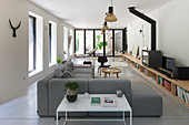 Grey corner sofa and long, low sideboard in modern living room