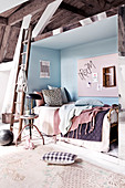 Bett in der Wandnische im rustikalen Schlafzimmer in Pastellfarben