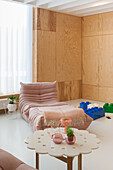 Bright living room with wood paneling and toy building blocks