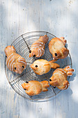 Hen-shaped sweet buns for Easter on cooling rack