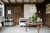 Interior of rustic summerhouse with wooden walls and white floor