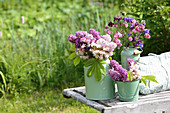 Bouquets of lilacs, aquilegia and branches of chestnut leaves