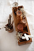 Bohemian-style arrangement of sticks, wooden candle holders and dried flowers