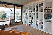 Large bookshelf in modern living room with a view of the outdoors