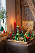 Festive arrangement of handmade paper Christmas trees and candles