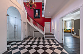Chequered floor and chandelier in spacious foyer