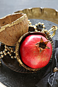 Pomegranate arranged in gold-painted coconut shell