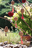 Handmade brown paper pendants with tassels as decorations for garden party
