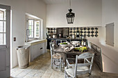 Dining table in rustic kitchen in French country house