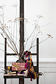 Wrapped gifts, ethnic-style accessories and dried flowers on easel