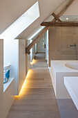 Attic bathroom with wooden beams, shower and sink