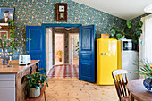 Blue double doors and yellow retro fridge in kitchen-dining room