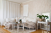 Blankets on corner sofa in beige, Bohemian-style living room