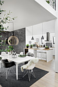 Dining table in modern, open-plan interior in grey and white