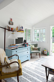 Pale blue chest of drawers in bright, vintage-style living room