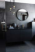 Modern, masculine bathroom decorated in black with golden accents