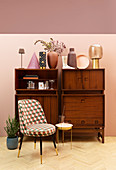 Vases on retro sideboard, easy chair and side table