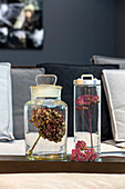 Dried hydrangea and yarrow flower heads in glass jars