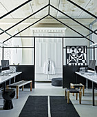 Black-and-white home workstations in house-shaped steel construction