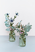 Small bouquets of eucalyptus, Eryngo, and waxflower