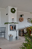 Tiled stove in Scandinavian-style living room decorated for Christmas