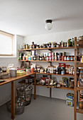 Groceries on simple wooden shelves in cellar