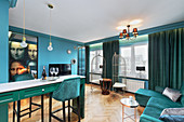 Open-plan apartment with turquoise colour scheme