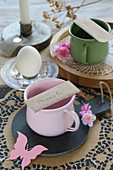 Name tag on cup on table set in romantic style
