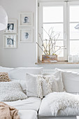 Scatter cushions with different textures in white living room