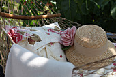 Cushions and straw hat on hammock