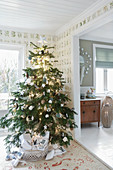 Decorated Christmas tree in rustic living room