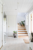 White foyer with staircase