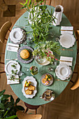 Table set in Mediterranean style with pale green tablecloth