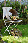 Wreath of hydrangeas in old zinc tub without base on chair