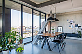 Dining area with glass wall in loft apartment