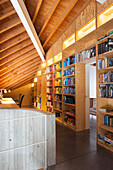 Wooden bookshelf floor to sloping ceiling