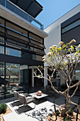 Seating area in courtyard garden of modern architect-designed house