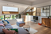 Modern living room with open-plan kitchen and view of the yard