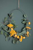 Wreath of eucalyptus twigs, yarrow and yellow felt balls