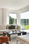 Floor-to-ceiling windows in elegant living room overlooking garden